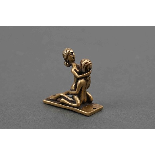 325 - A small figure of an erotic couple.