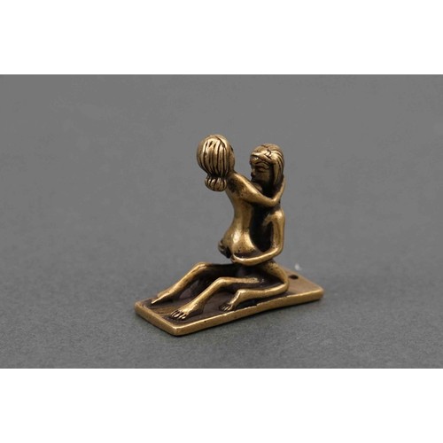 325 - A small figure of an erotic couple.