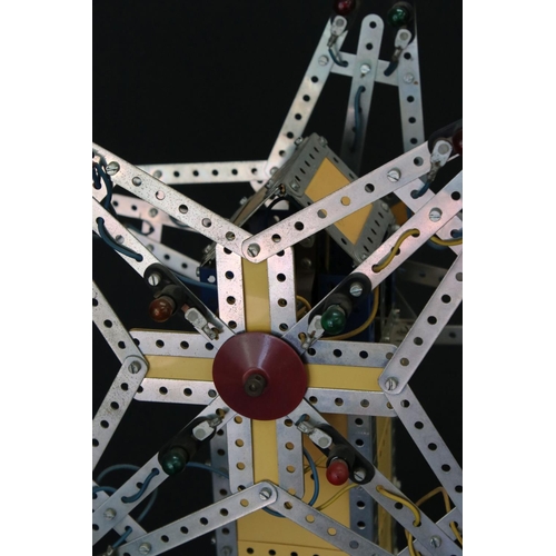 176 - Meccano mechanical windmill, with star to each side, on wooden stand, with lights, untested, on a wo... 