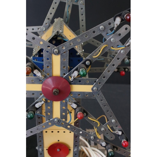 176 - Meccano mechanical windmill, with star to each side, on wooden stand, with lights, untested, on a wo... 