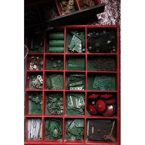 183 - Large four door cabinet containing various Meccano accessories, several colours, showing some wear