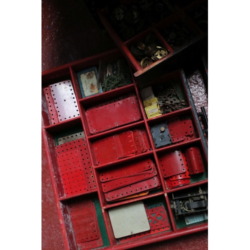 183 - Large four door cabinet containing various Meccano accessories, several colours, showing some wear