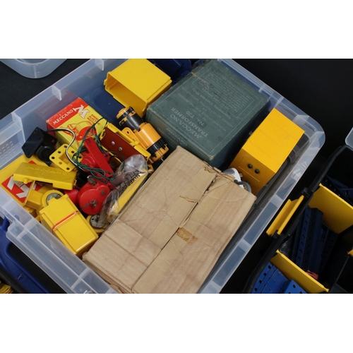 185 - Four plastic containers of various Meccano items and accessories to include a container of blue & ye... 