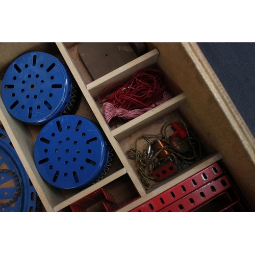 220 - Quantity of Marklin construction accessories and parts, various colours, within wooden box that has ... 