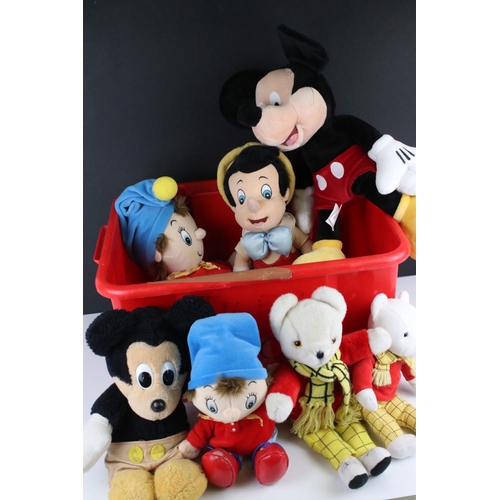 294 - A collection of soft toys to include Noddy, Mickey Mouse and Pinocchio.