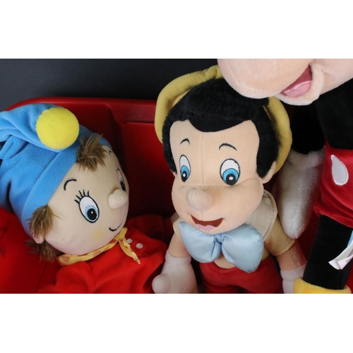 294 - A collection of soft toys to include Noddy, Mickey Mouse and Pinocchio.