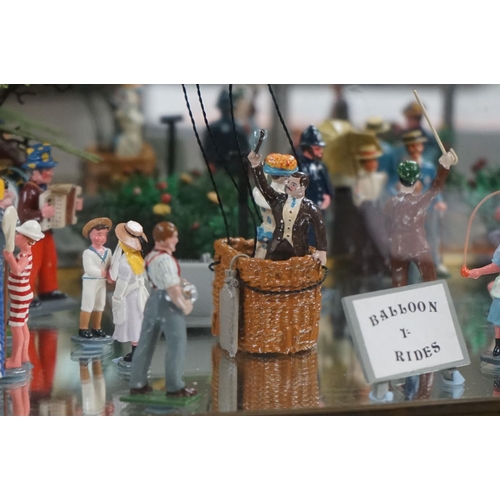 262 - A glass cased diorama titled 'Balloon Rides' with a display of painted metal figures and a suspended... 