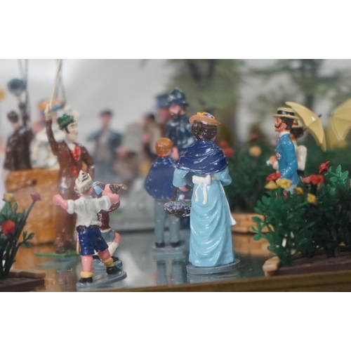 262 - A glass cased diorama titled 'Balloon Rides' with a display of painted metal figures and a suspended... 