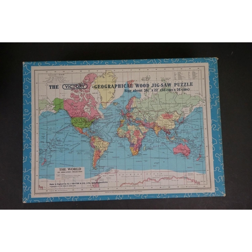 1076 - A collection of five vintage jigsaws to include the Victory Geographical wood jigsaw puzzle and the ... 