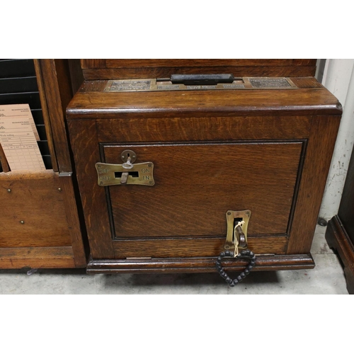38 - An early 20th century oak cased Gledhill Brook Time Recorder clocking in clock together with a wall ... 