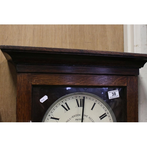38 - An early 20th century oak cased Gledhill Brook Time Recorder clocking in clock together with a wall ... 