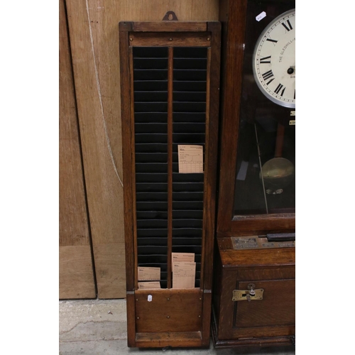 38 - An early 20th century oak cased Gledhill Brook Time Recorder clocking in clock together with a wall ... 
