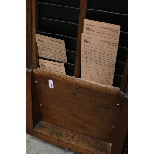 38 - An early 20th century oak cased Gledhill Brook Time Recorder clocking in clock together with a wall ... 