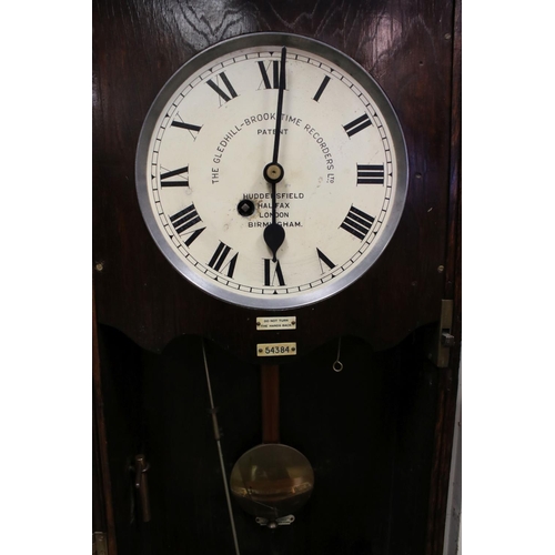 38 - An early 20th century oak cased Gledhill Brook Time Recorder clocking in clock together with a wall ... 