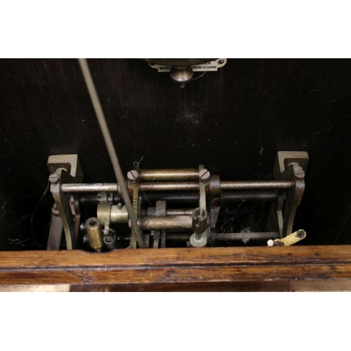 38 - An early 20th century oak cased Gledhill Brook Time Recorder clocking in clock together with a wall ... 