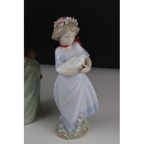 12 - Three Lladro figures to include Girl holding chicken, Girl looking coy and Girl holding doll.