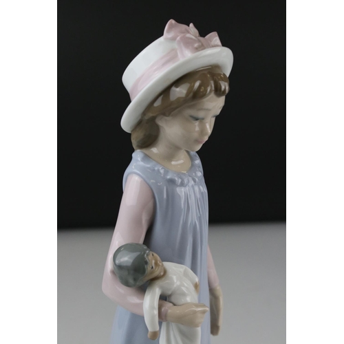 12 - Three Lladro figures to include Girl holding chicken, Girl looking coy and Girl holding doll.