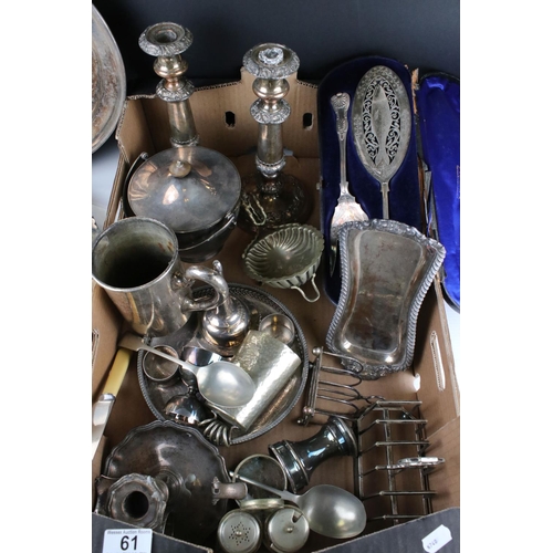 61 - A quantity of Silver plate and metal ware to include trays candle sticks tankards, toast racks, pepp... 