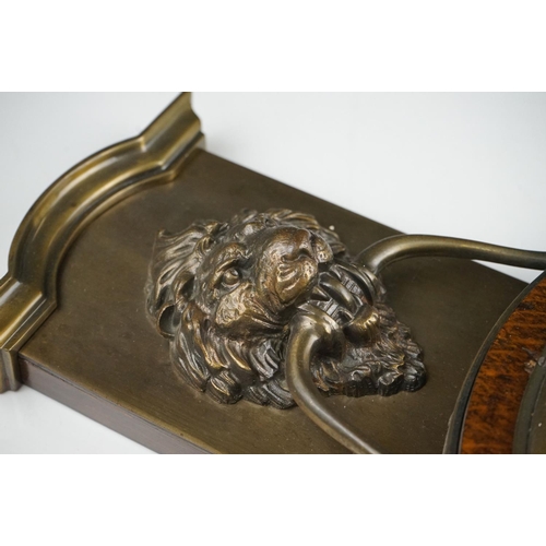 53 - An early 20th century oak cased barometer with lion mask decoration.