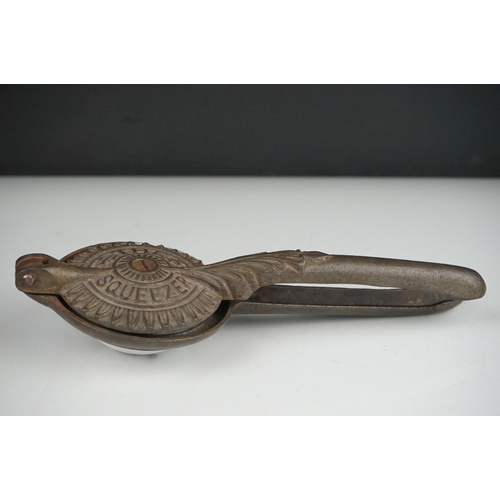 54 - An early 20th century cast iron Lemon Squeezer with insert.