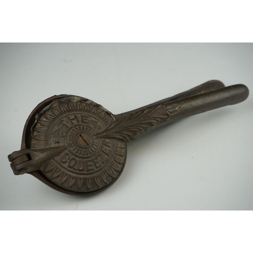 54 - An early 20th century cast iron Lemon Squeezer with insert.