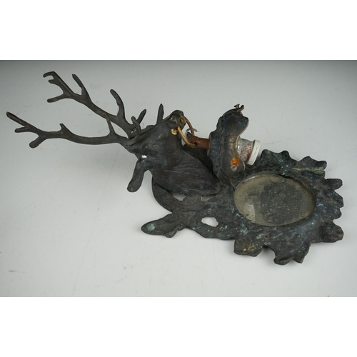 56 - A pair of metal mirrored wall sconces with stag decoration.