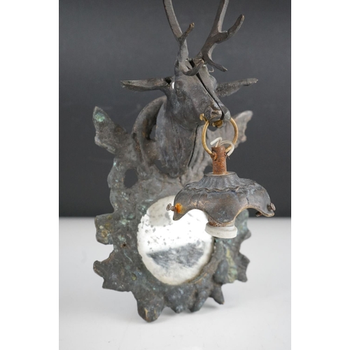 56 - A pair of metal mirrored wall sconces with stag decoration.