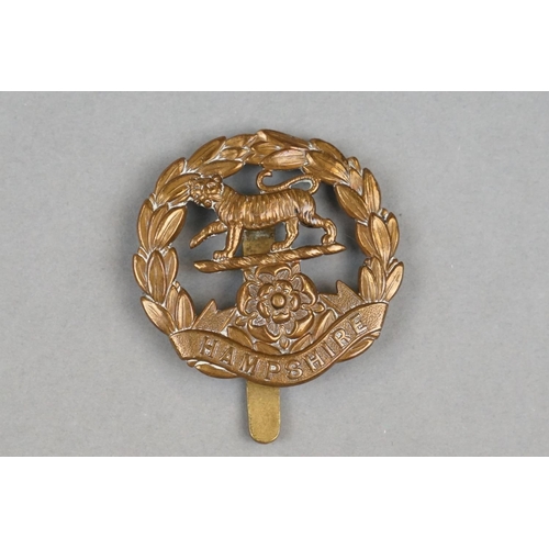 16 - A British Military The Hampshire Regiment Brass Cap Badge With Slider Fixing Too Verso.