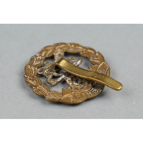 16 - A British Military The Hampshire Regiment Brass Cap Badge With Slider Fixing Too Verso.