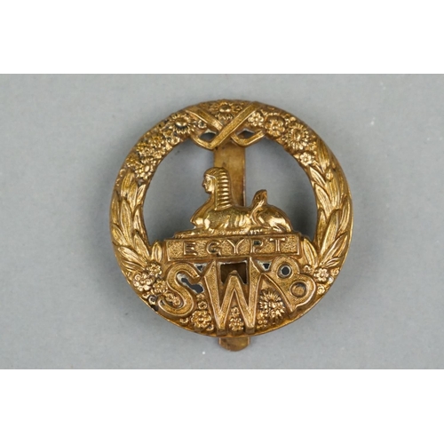 19 - A British Military The South Wales Border Regiment Brass Cap Badge With Slider Fixing Too Verso.