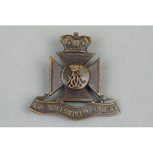 25 - A British Military The Wiltshire Regiment OSD Cap Badge With Twin Strap Fixings To Verso.
