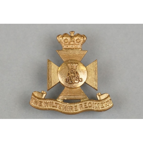 26 - A British Military The Wiltshire Regiment Gilt Officers Cap Badge With Triple Loop Fixings To Verso.