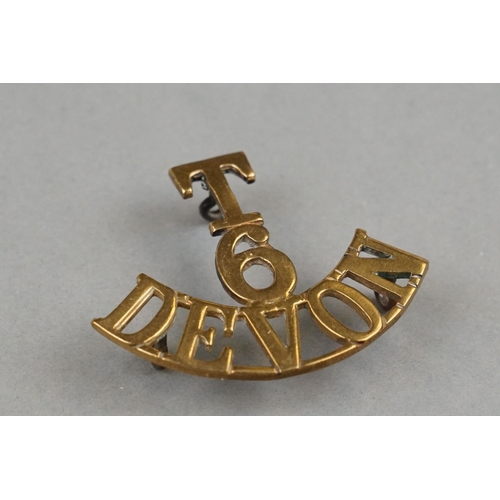 38 - Three British Military Brass Shoulder Titles To Include The 5th Battalion Of The Devon Regiment, The... 