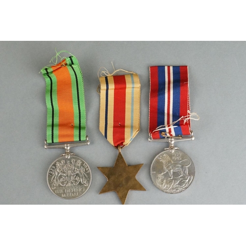 46 - A British World War Two Full Size Medal Group Of Three To Include The 1939-1945 British War Medal, T... 