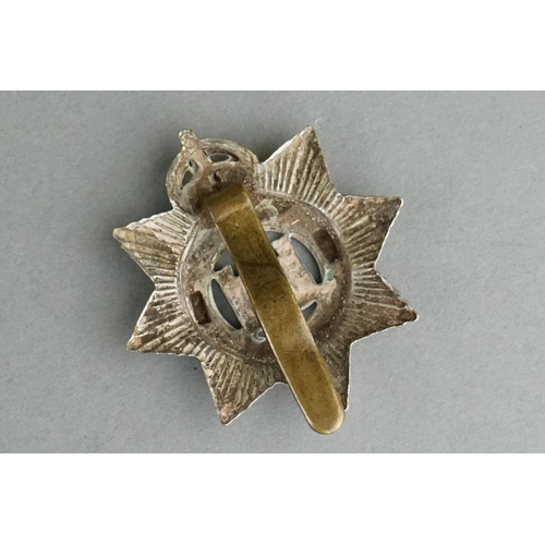 75 - A British Military The Devonshire Regiment Bi Metal Cap Badge With Slider Fixing To Verso Together W... 