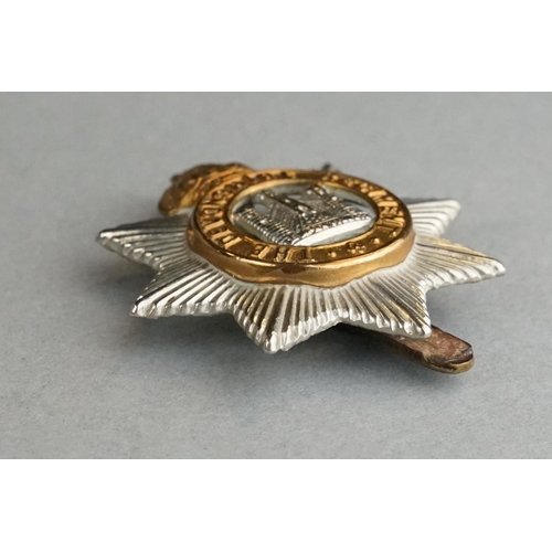 75 - A British Military The Devonshire Regiment Bi Metal Cap Badge With Slider Fixing To Verso Together W... 