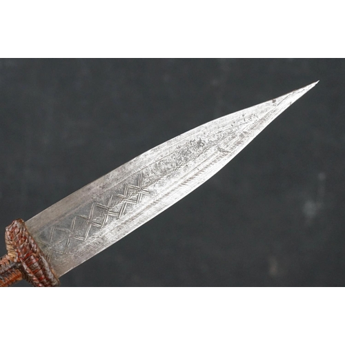 121 - A Vintage African Dagger With Stitch Detailing To Blade Together With Original Leather Sheath.