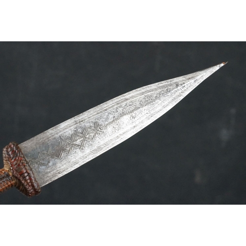 121 - A Vintage African Dagger With Stitch Detailing To Blade Together With Original Leather Sheath.