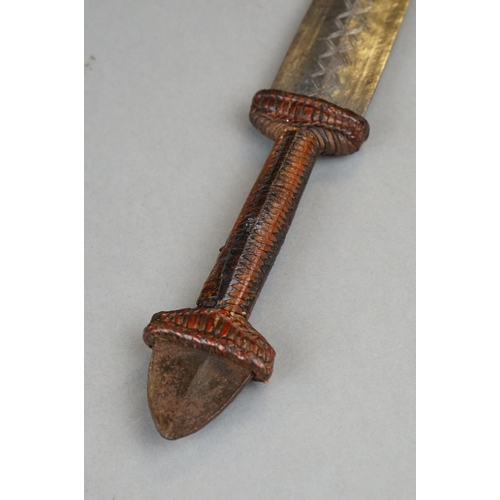 121 - A Vintage African Dagger With Stitch Detailing To Blade Together With Original Leather Sheath.