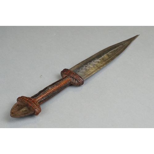 121 - A Vintage African Dagger With Stitch Detailing To Blade Together With Original Leather Sheath.