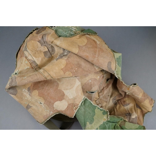 166 - A Military Helmet Complete With Original Liner And Outer Camouflage Cover.