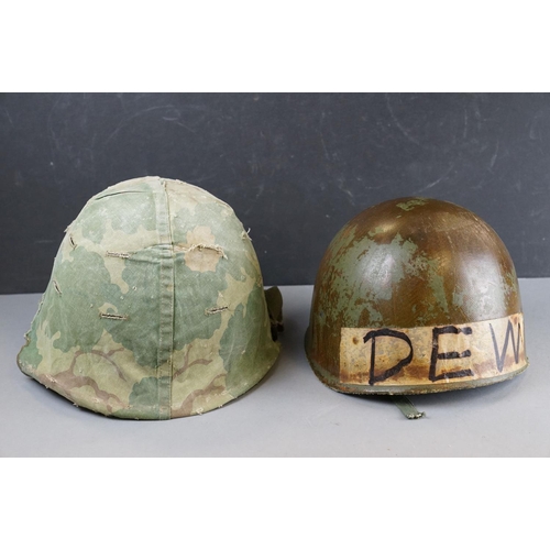 166 - A Military Helmet Complete With Original Liner And Outer Camouflage Cover.