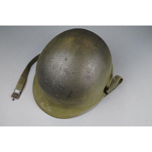 166 - A Military Helmet Complete With Original Liner And Outer Camouflage Cover.