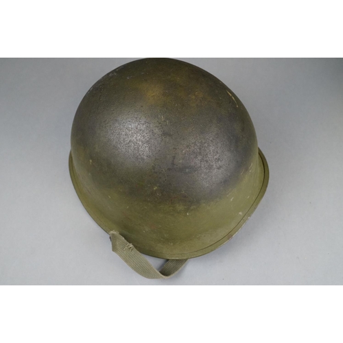 166 - A Military Helmet Complete With Original Liner And Outer Camouflage Cover.