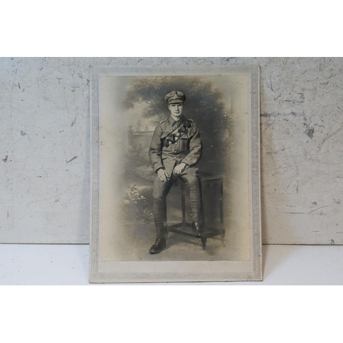 195 - A Large World War One Card Mounted Photograph Of A Soldier In Uniform With Leather Bandolier. Measur... 