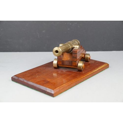 262 - A Decorative Brass Desktop Canon With Brass Wheels Mounted To Wooden Plinth.