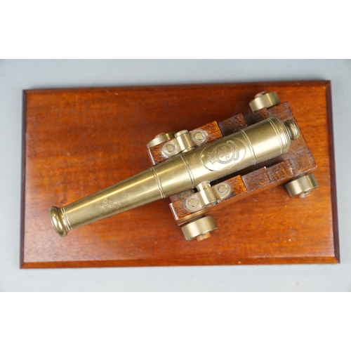 262 - A Decorative Brass Desktop Canon With Brass Wheels Mounted To Wooden Plinth.