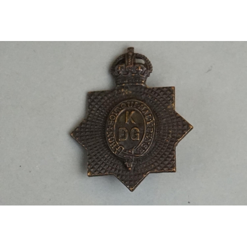 203 - A British Military Kings Dragoon Guards OSD Cap Badge With Kings Crown, Twin Blade Fixings To Verso.