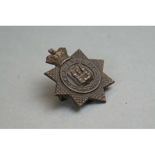 205 - A British Military East Surrey Regiment Bronze Cap Badge With Queen Victoria Crown, Twin Loop Fixing... 