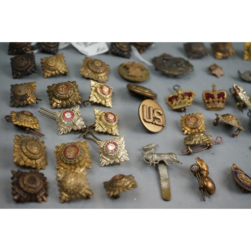 372 - A Collection Of Mainly British Military Badges To Include Officers Pips, Cap Badges, Collar Badges A... 